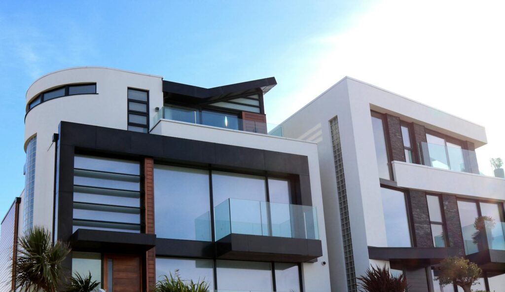 Contemporary luxury home with glass balconies in Poole, UK, showcasing modern architectural design.